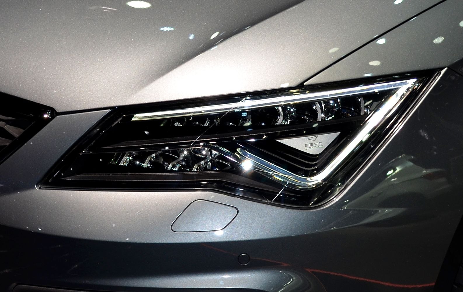 Sleek LED headlight with sharp, angular design and integrated lighting elements.