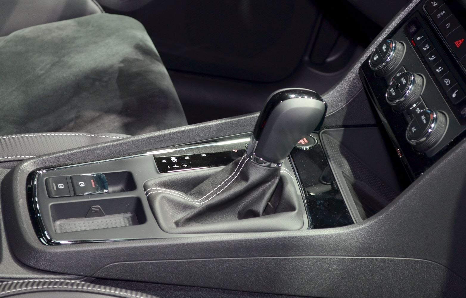 Automatic gear shift lever with climate control knobs on center console.