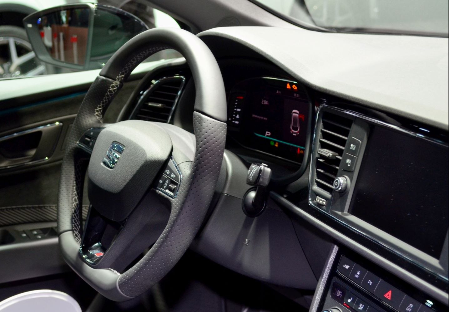 Steering wheel with control buttons, digital instrument cluster and center dashboard console