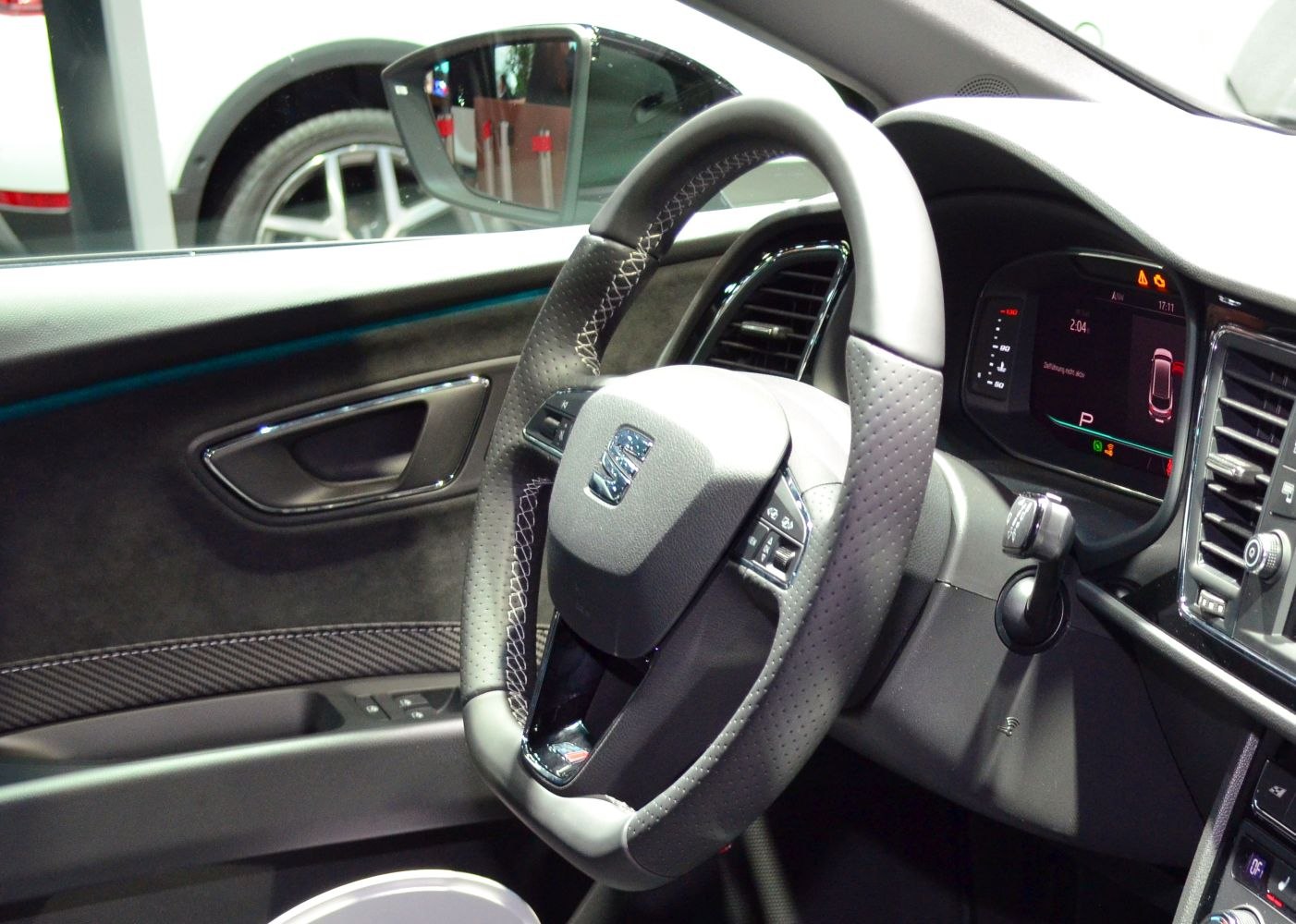 Steering wheel with stitched leather and digital dashboard inside car