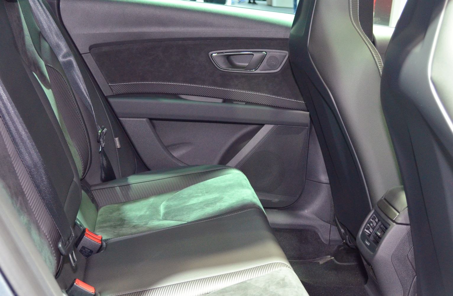 Rear seat and door panel with leather and suede upholstery.