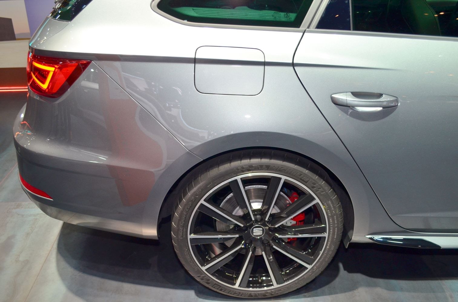 Rear side of grey hatchback with alloy wheel, fuel cap, tail light