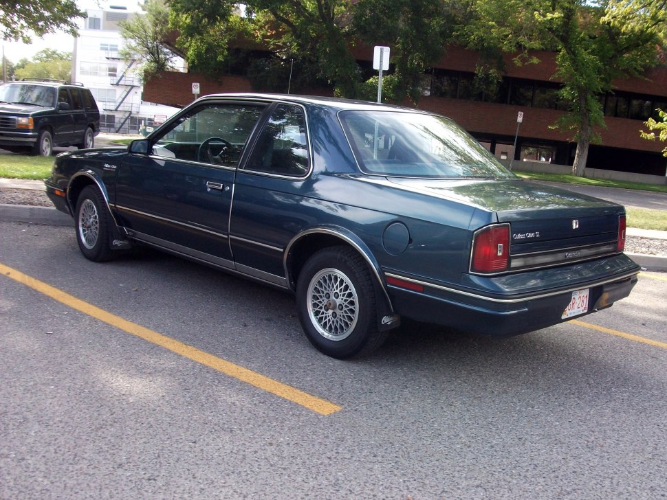 Rear and side view of classic coupe with vintage wheels