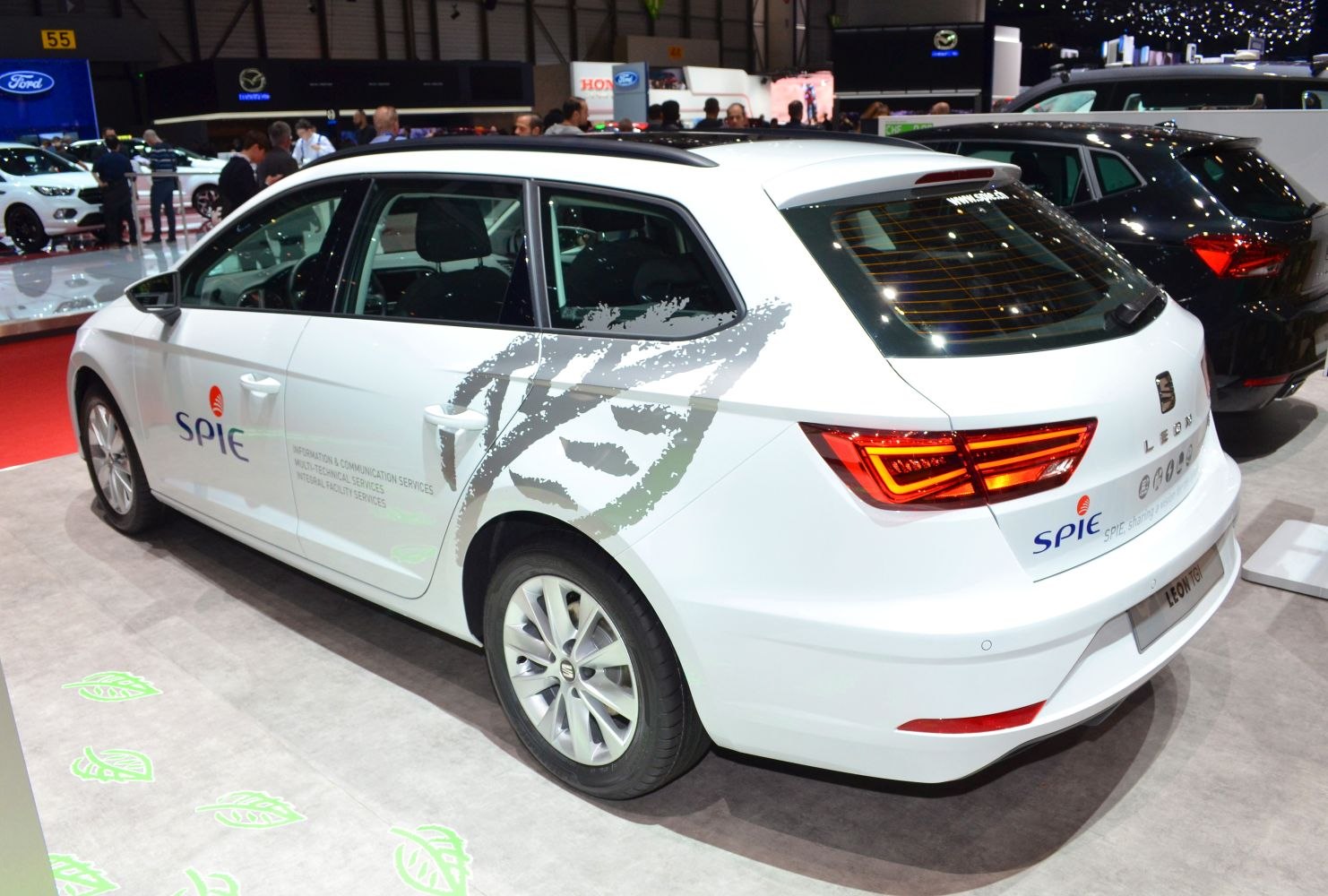 White station wagon rear-side view with LED tail lights and roof spoiler