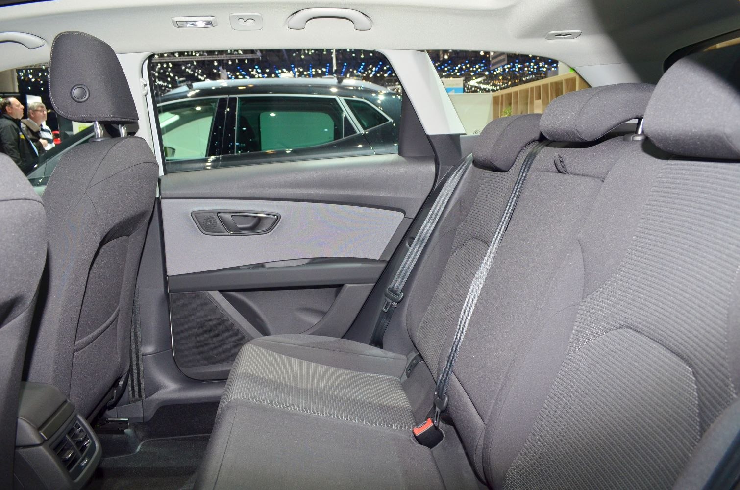 Rear passenger seat area with fabric upholstery and door panel