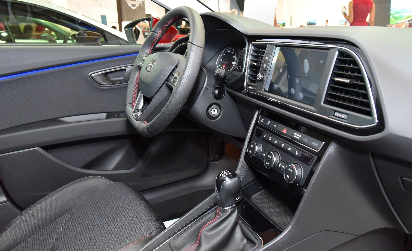 Dashboard, steering wheel, touchscreen infotainment, manual gear shifter