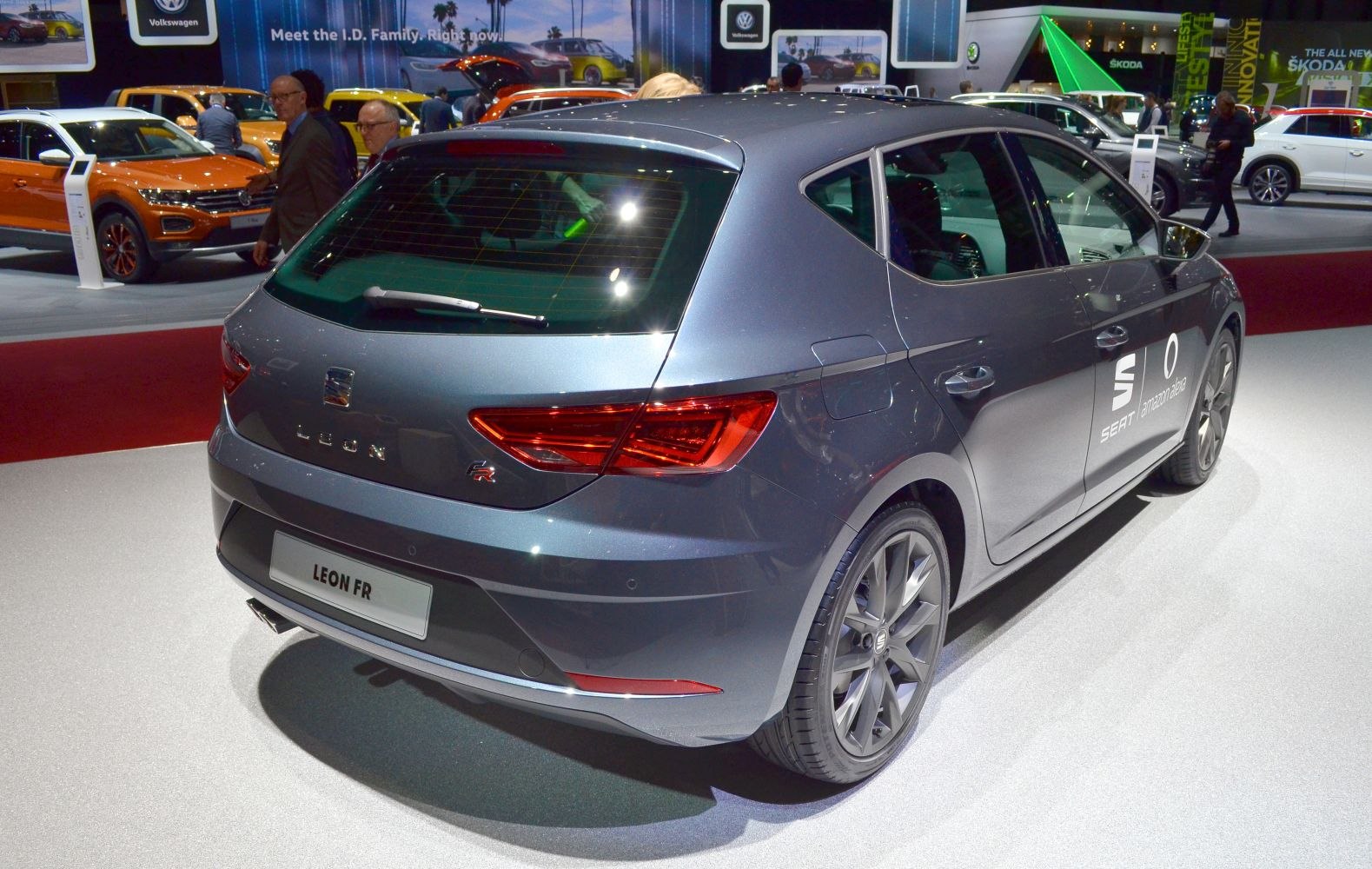 Rear view showing sporty taillights, alloy wheels, and dual exhaust of a facelift hatchback