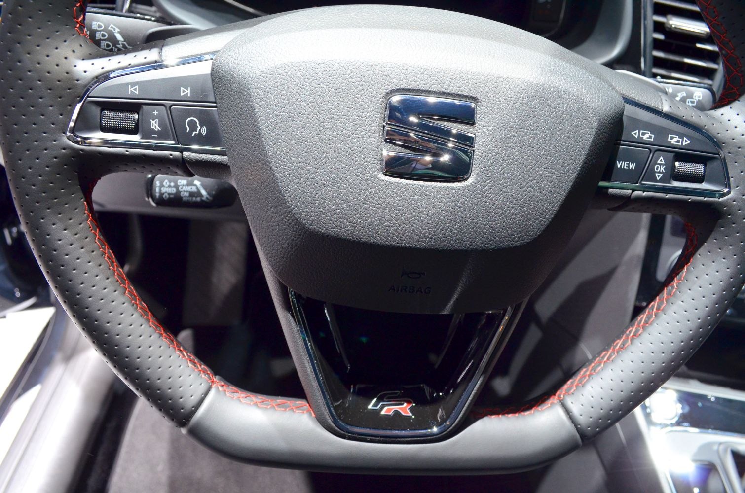 Performance steering wheel with red stitching and multifunction buttons