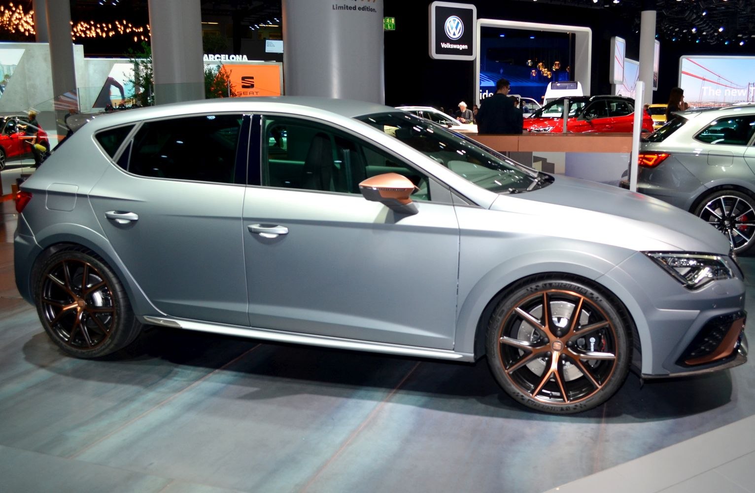 Side profile of sporty hatchback with bronze-accented alloy wheels