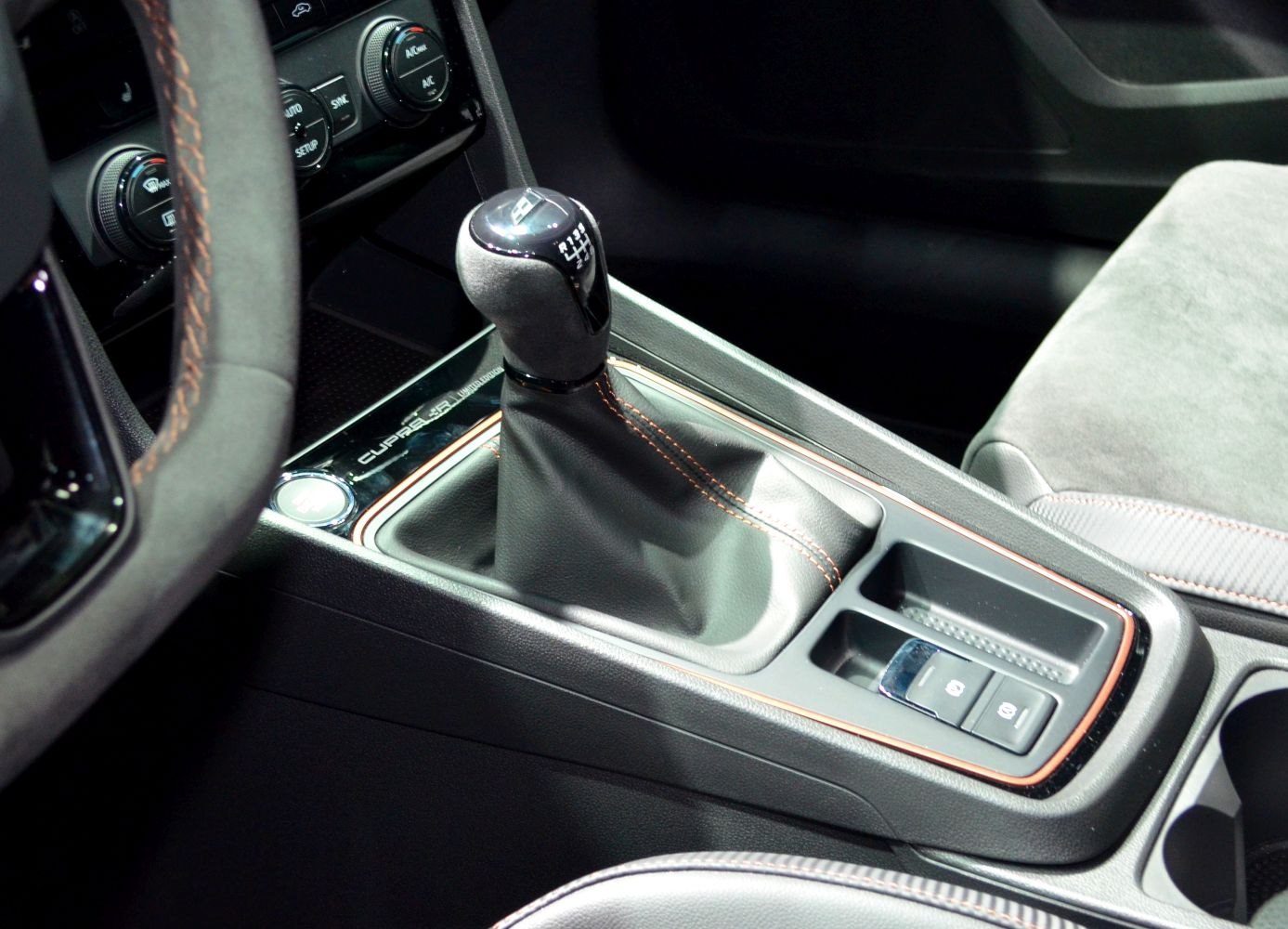 Manual gear shift with Cupra branding and detailed stitching on central console