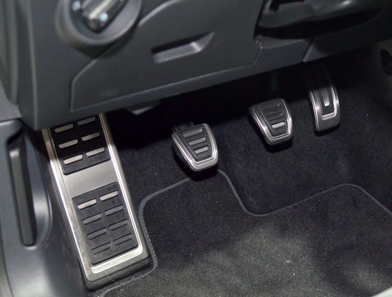 Close-up of sporty aluminum pedals with rubber grips.