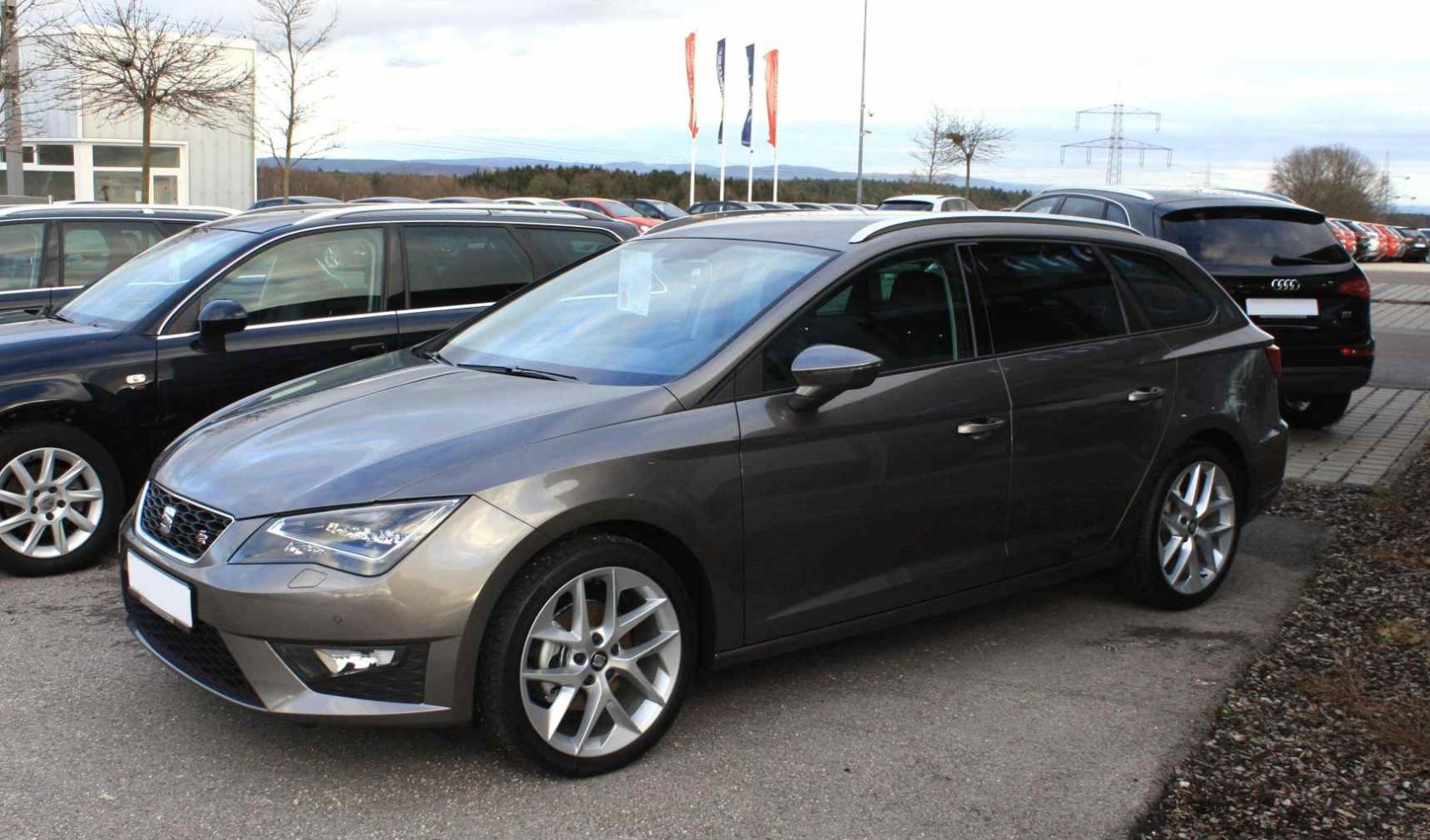 Silver estate vehicle with angular LED headlights and alloy wheels.