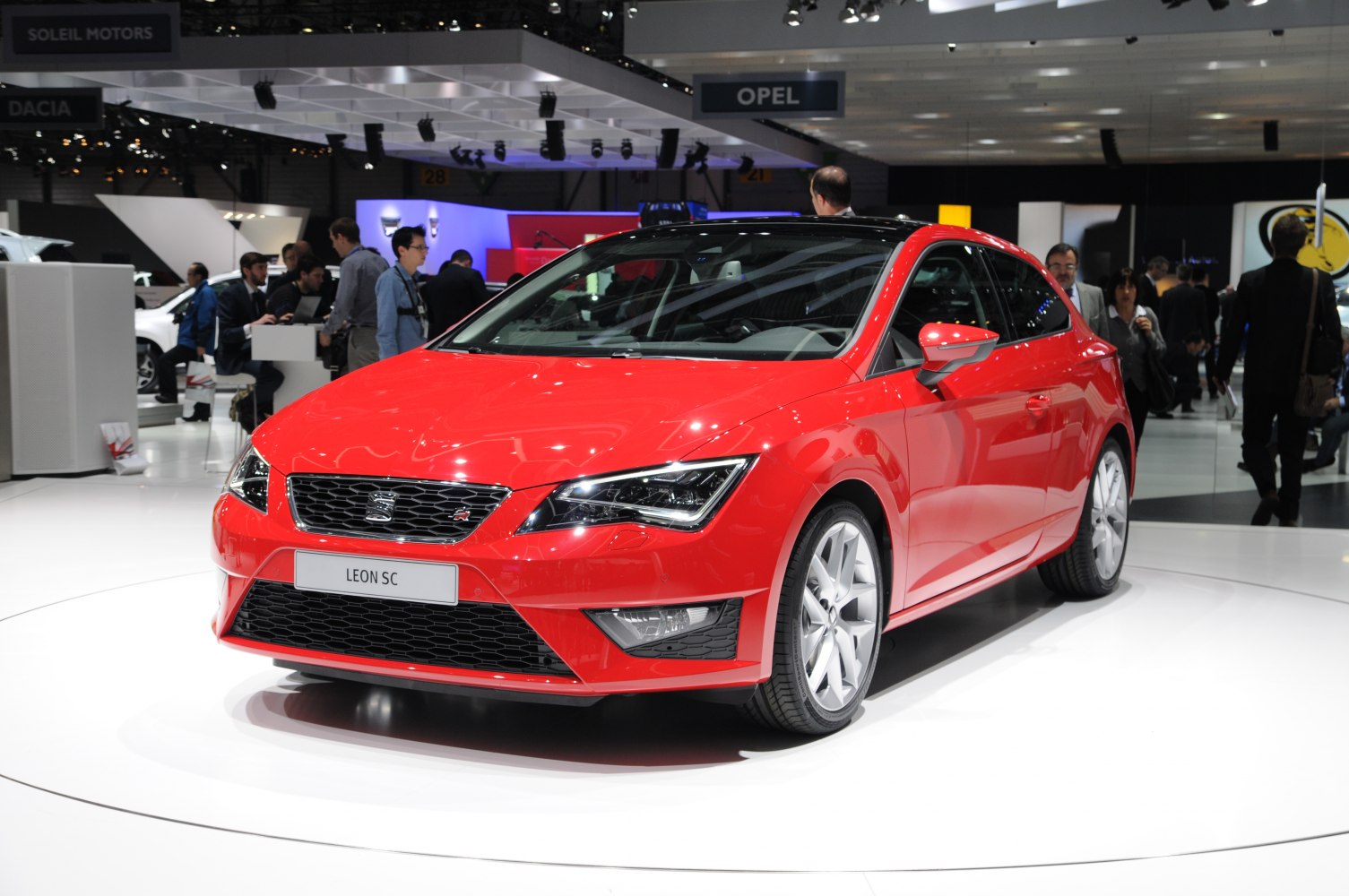Sporty red compact hatchback with aggressive grille and LED headlights