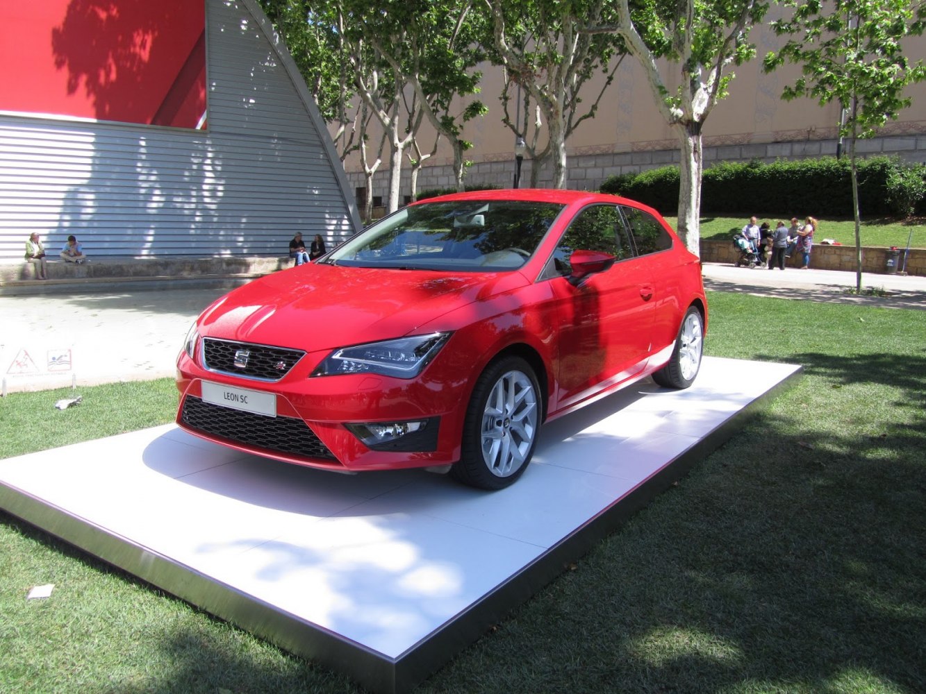 Red hatchback with sporty front design and alloy wheels