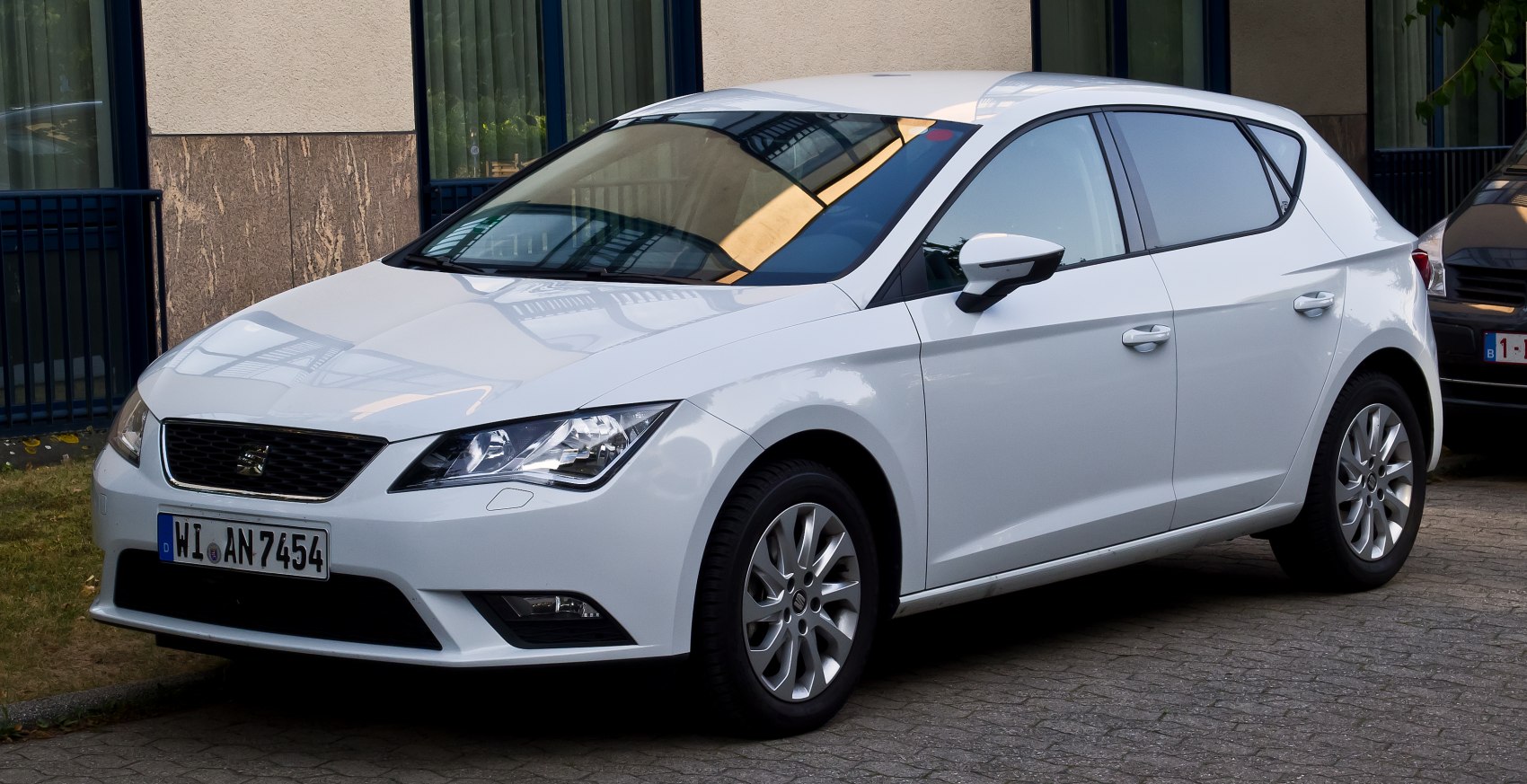 White hatchback with angular headlights and alloy wheels