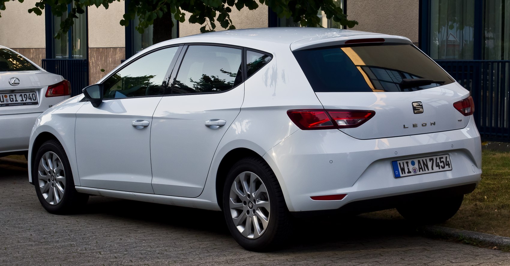 Rear side view of white hatchback with distinctive taillights and alloy wheels