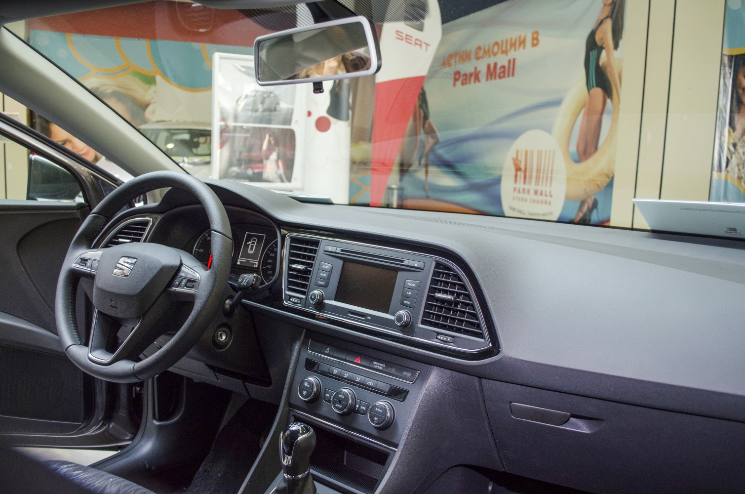 Steering wheel, dashboard, and center console with infotainment and climate controls