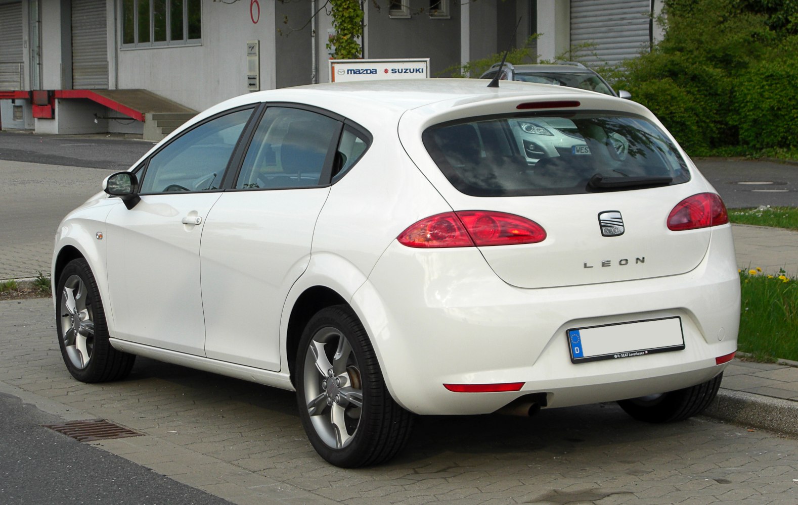 Rear and side profile of white hatchback with curved rear lights and five-door design