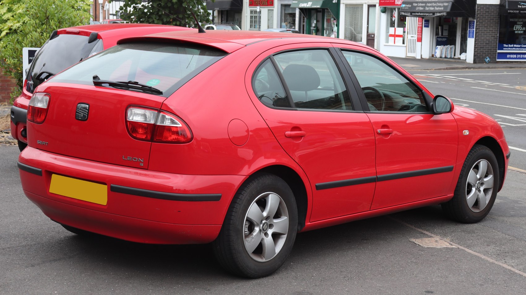 Red hatchback with rear perspective and alloy wheels