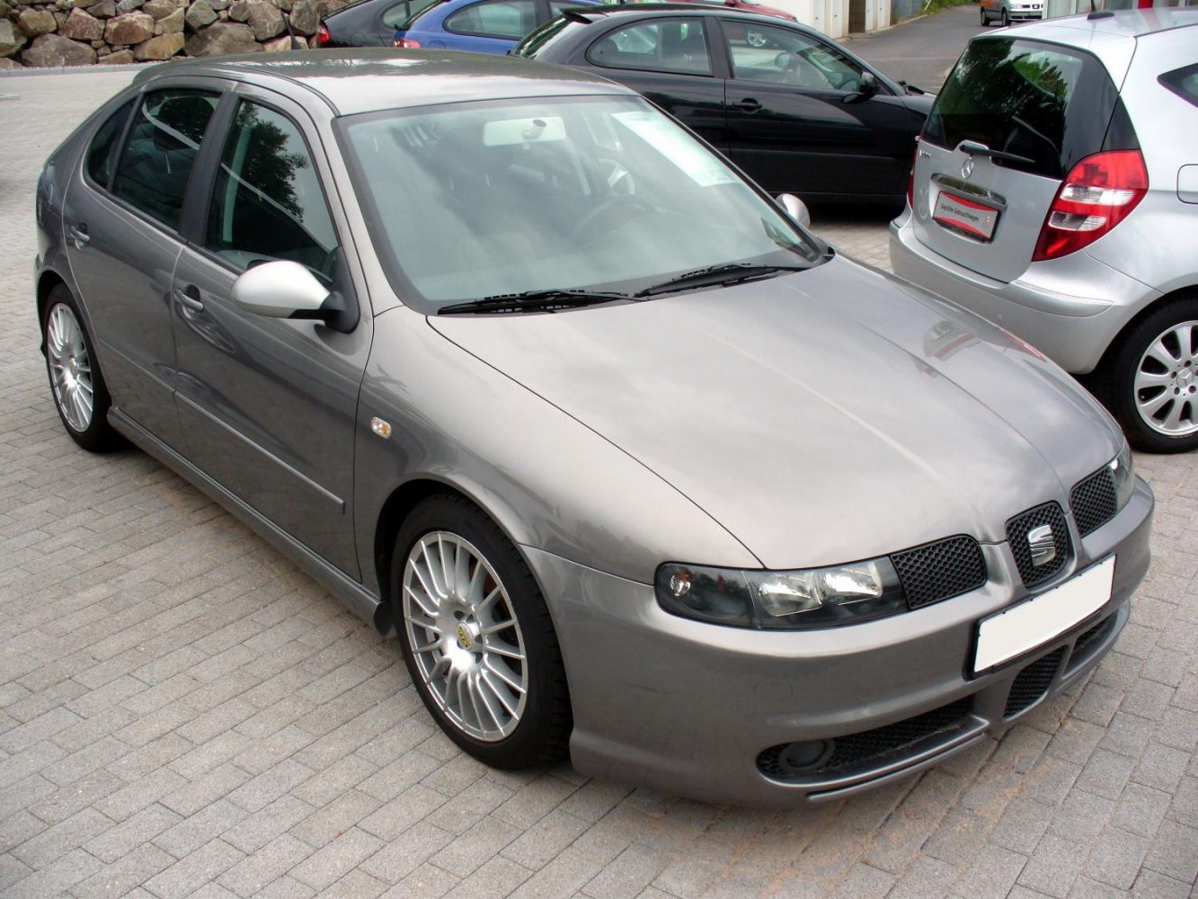 Front three-quarter view of hatchback with sporty alloy wheels and distinctive headlights