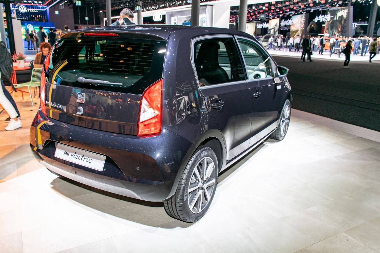 Rear and side perspective of a compact electric hatchback with modern tail lamps and alloy wheels