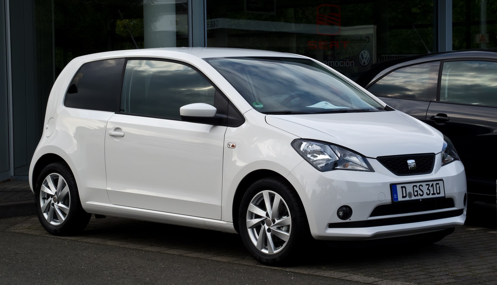 Compact white three-door hatchback with alloy wheels
