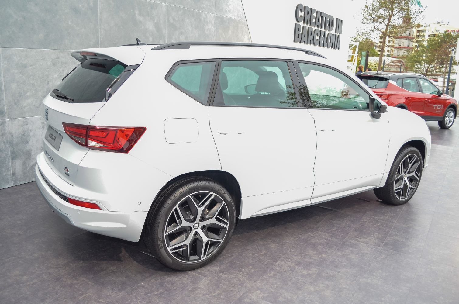 Rear side view of a white SUV with sharp taillights and alloy wheels