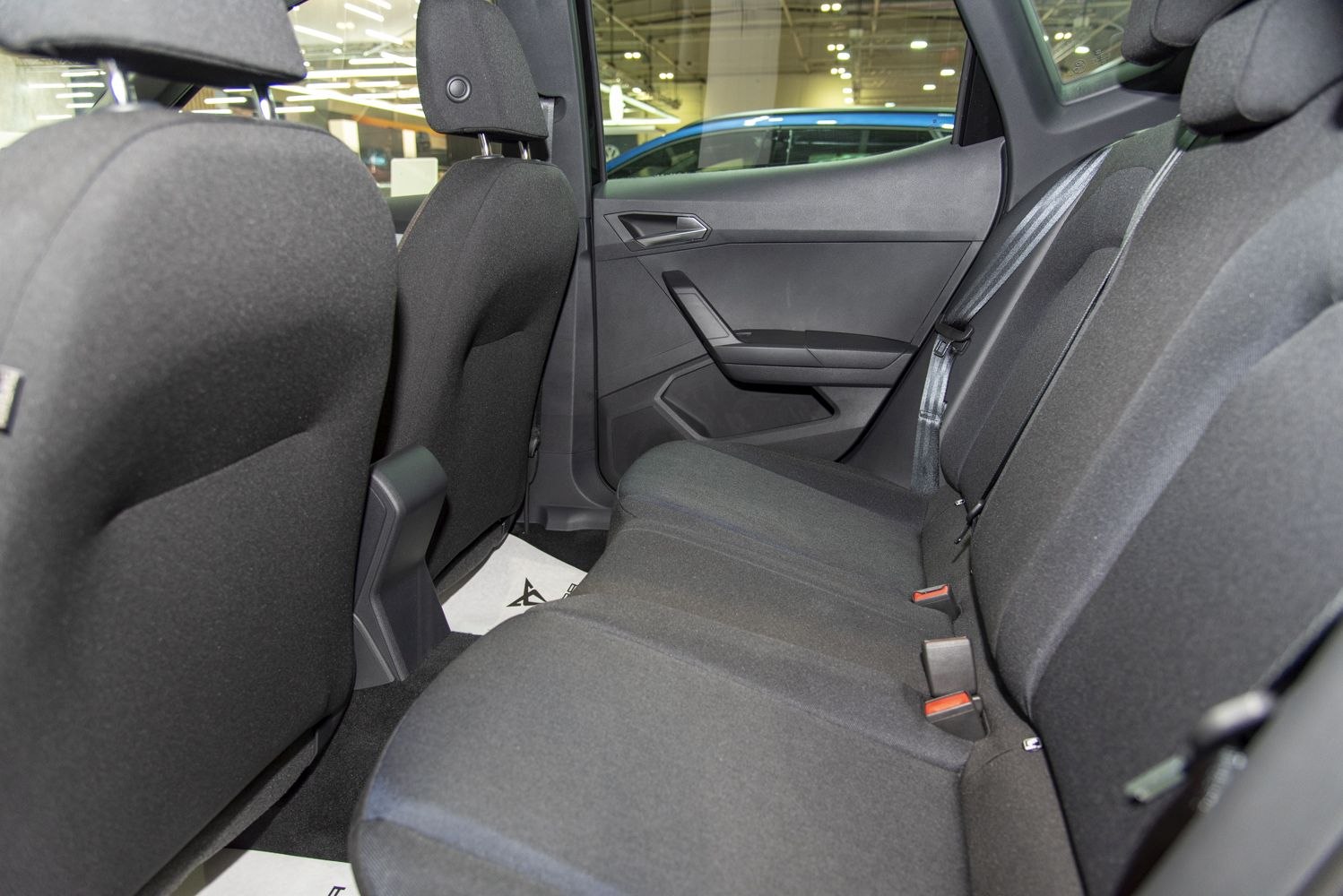 Rear seat interior with black fabric upholstery and modern door panel