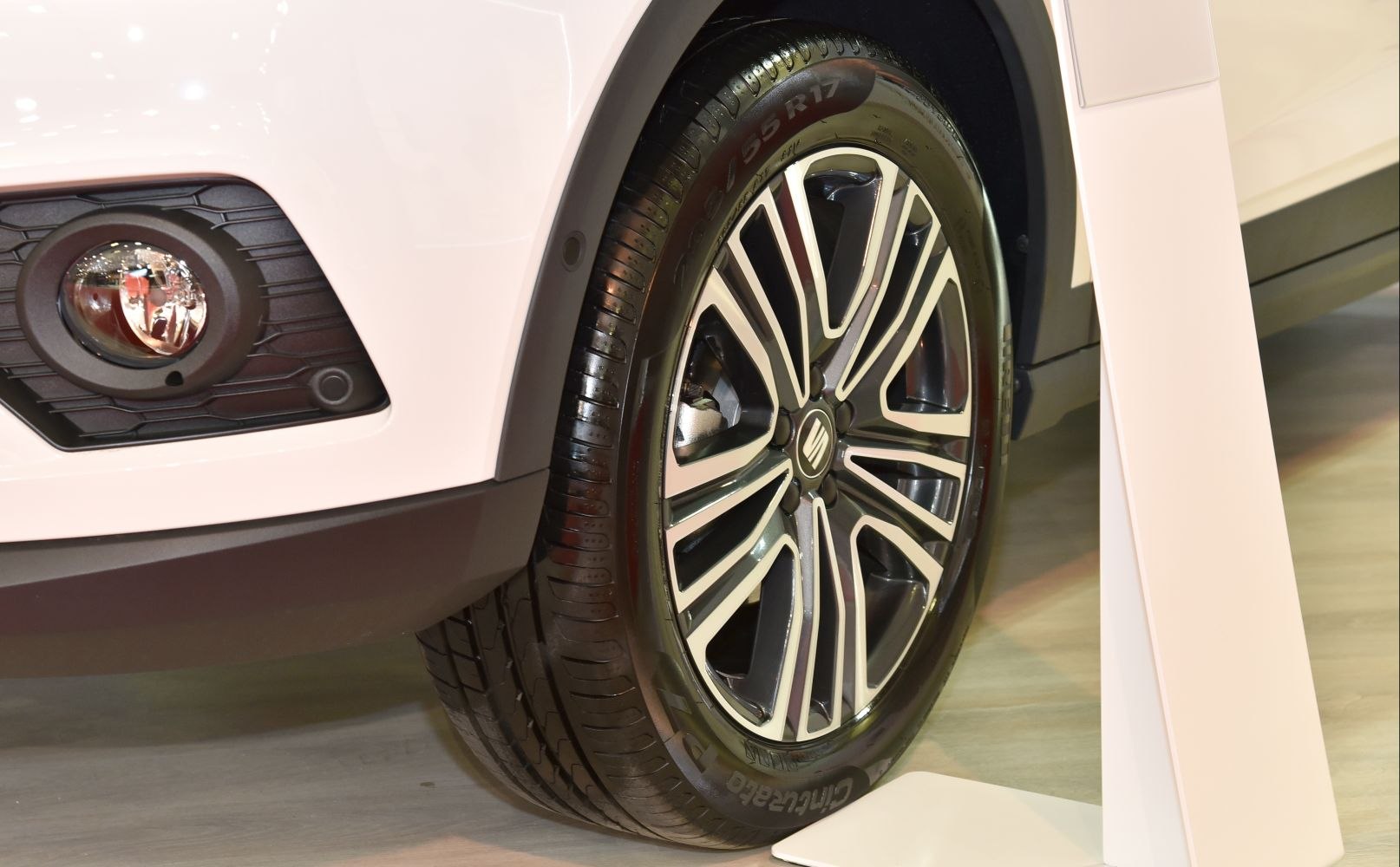 Detailed close-up of alloy wheel and front fog lamp.