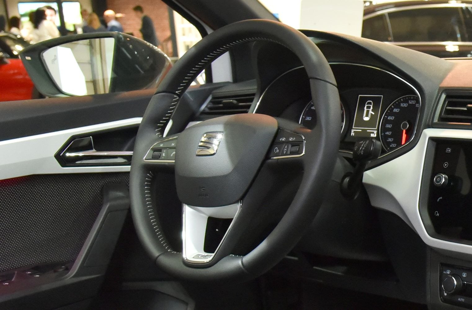 Multifunction steering wheel and dashboard close-up with interior controls