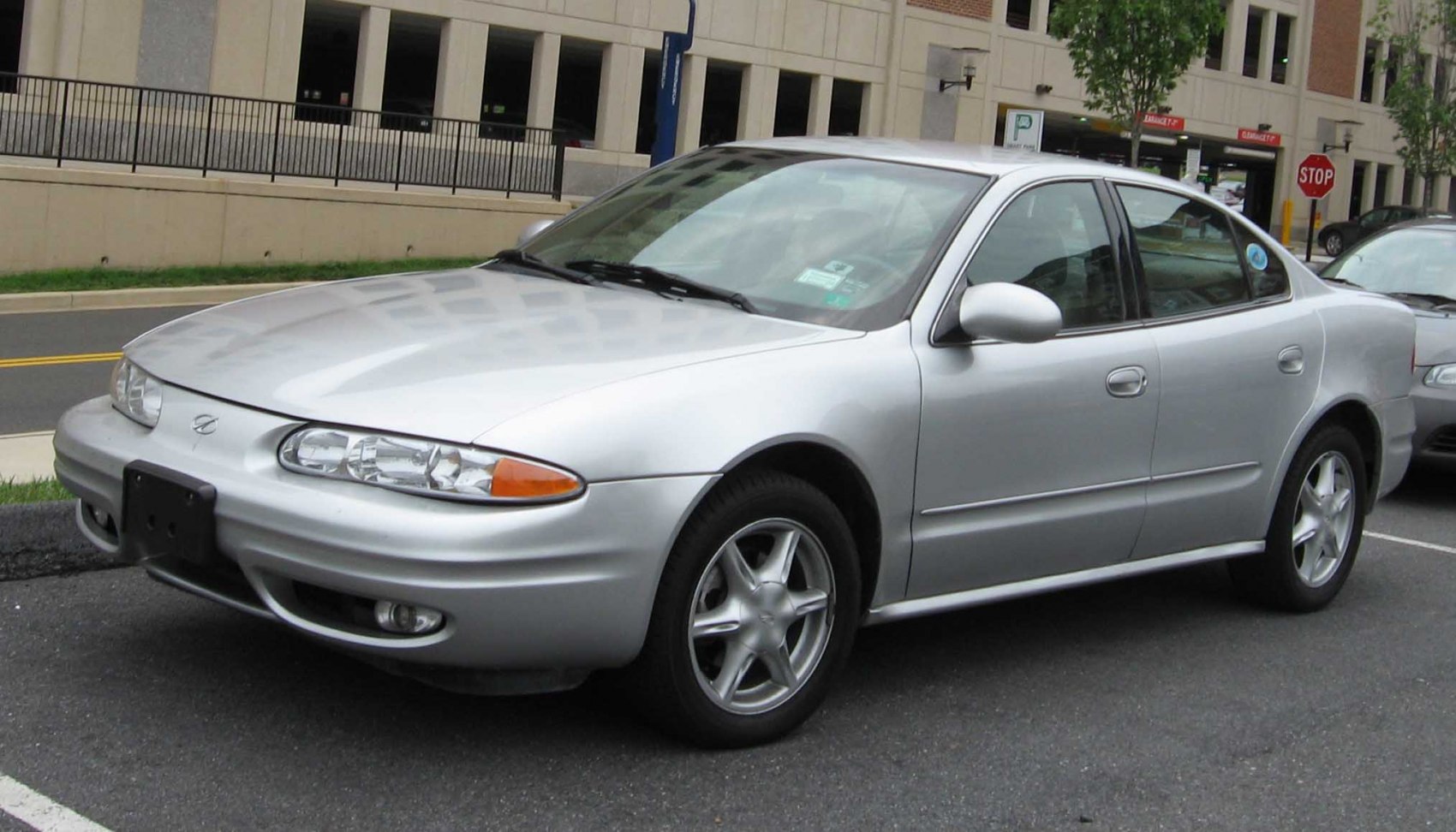 Four-door sedan with rounded headlights and five-spoke wheels