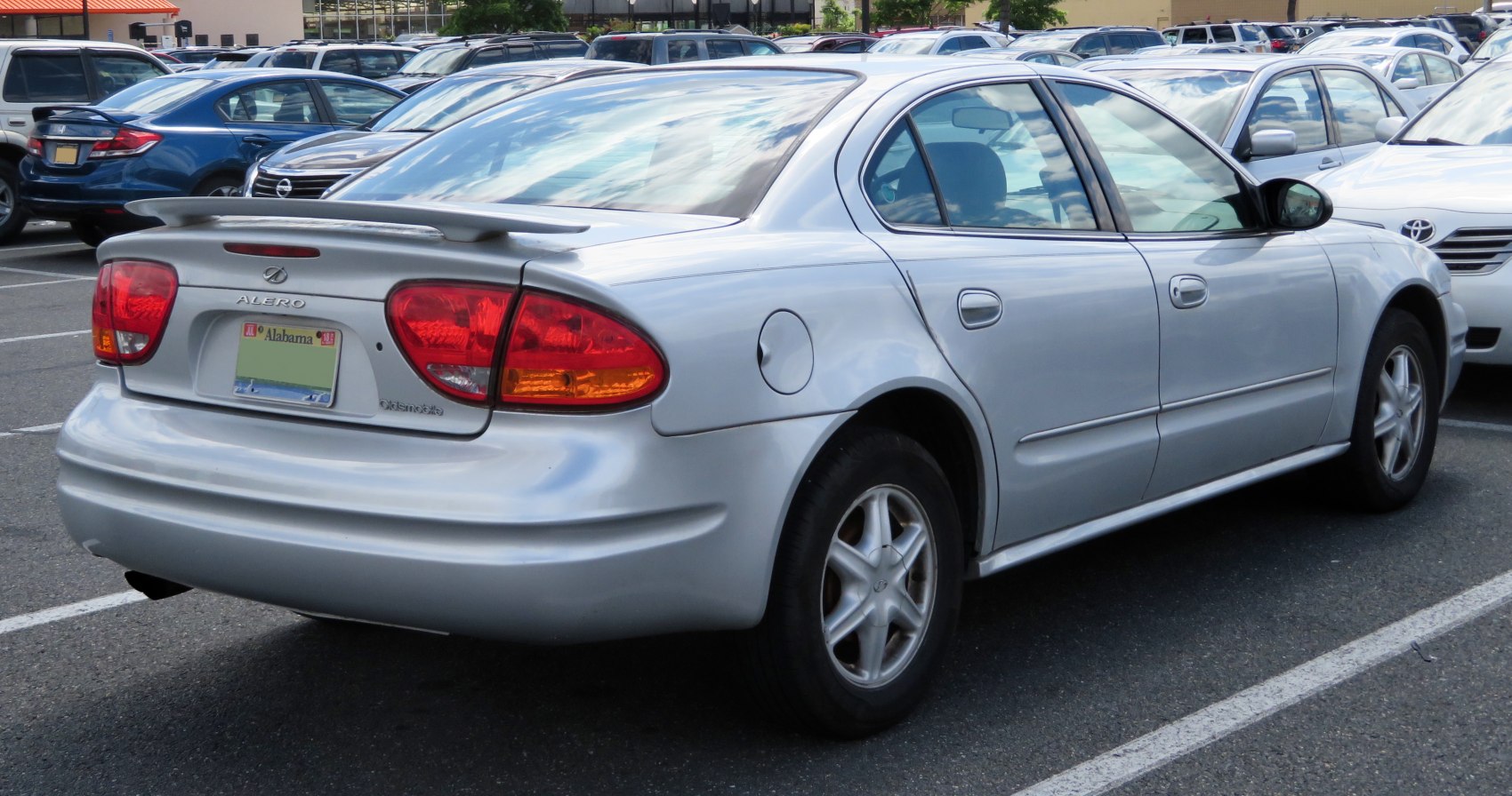 Silver sedan rear side with spoiler and tail lights