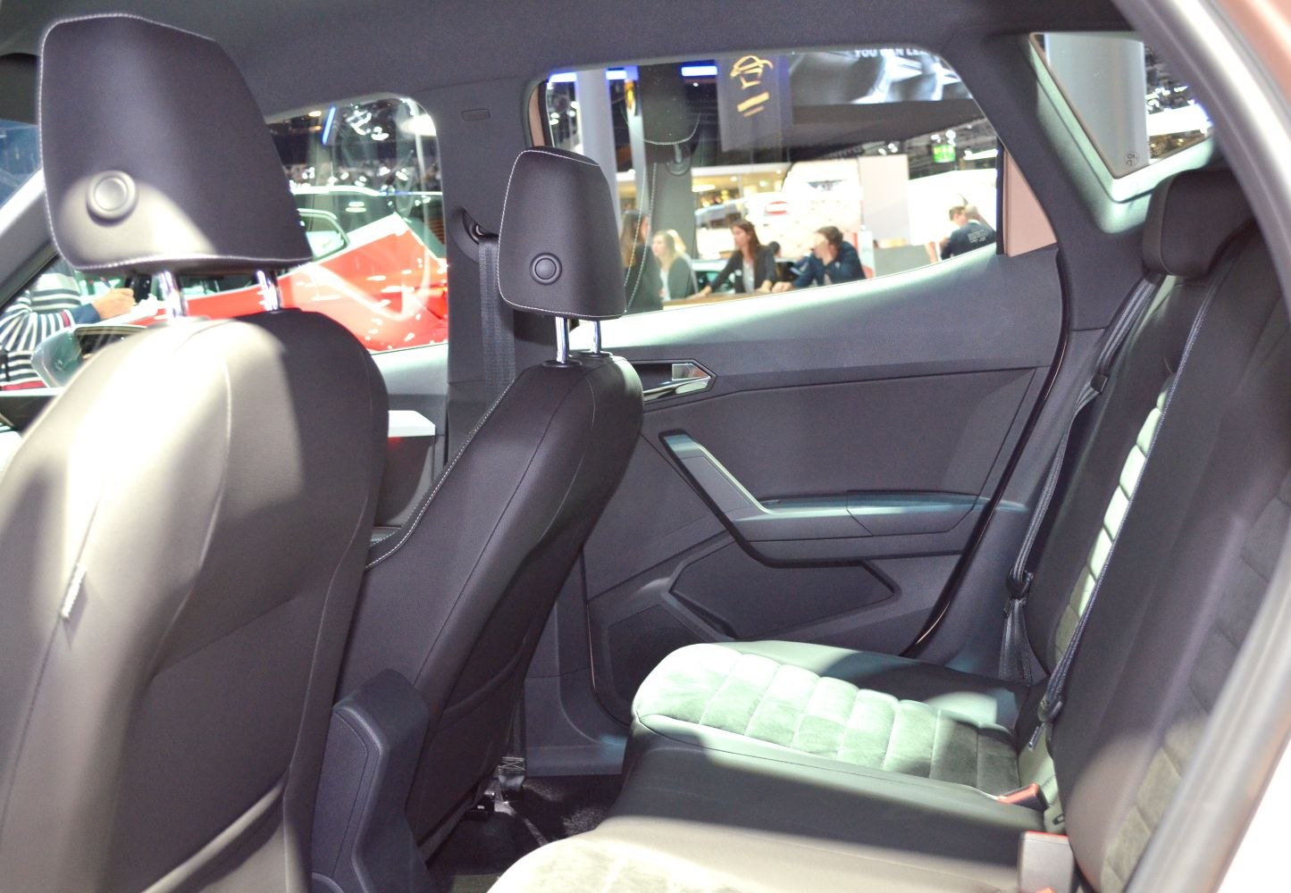 Rear seat interior with black upholstery and door panel.