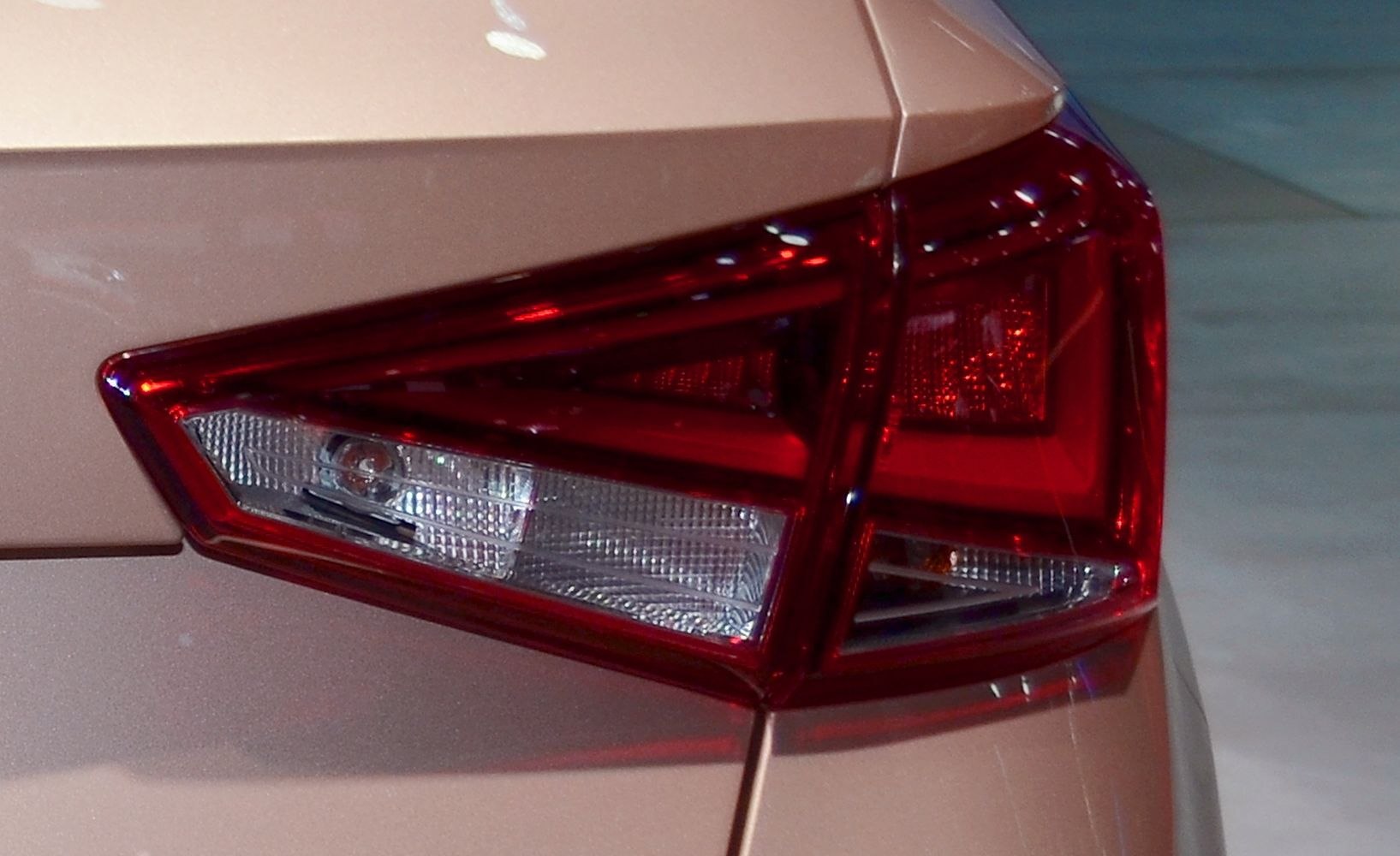 Close-up of angular rear tail light with segmented clear and red lenses