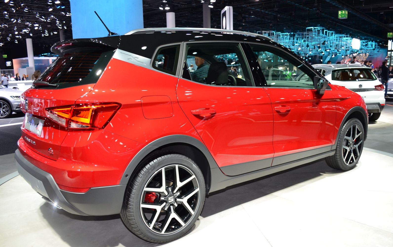 Red compact SUV rear side with black roof and alloy wheels