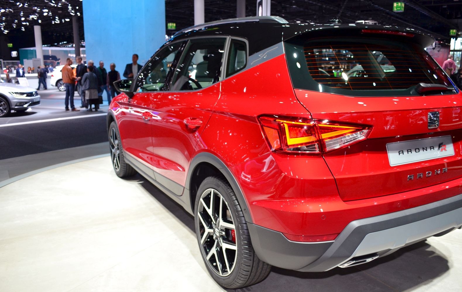 Rear and side profile of red compact SUV with black roof and LED tail lights