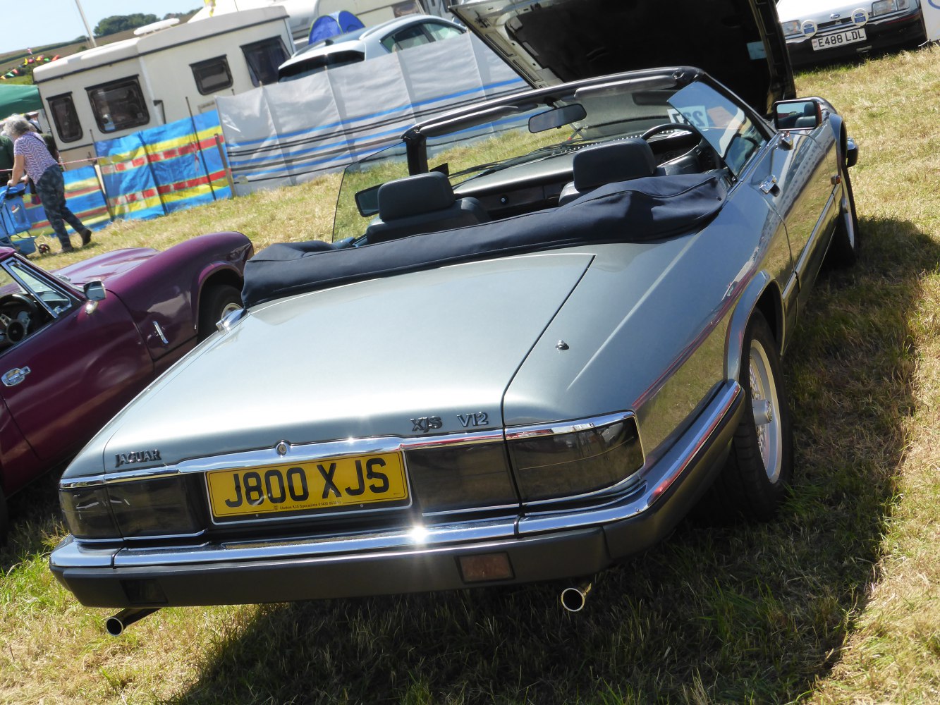 Rear view of classic convertible with V12 engine and soft top roof