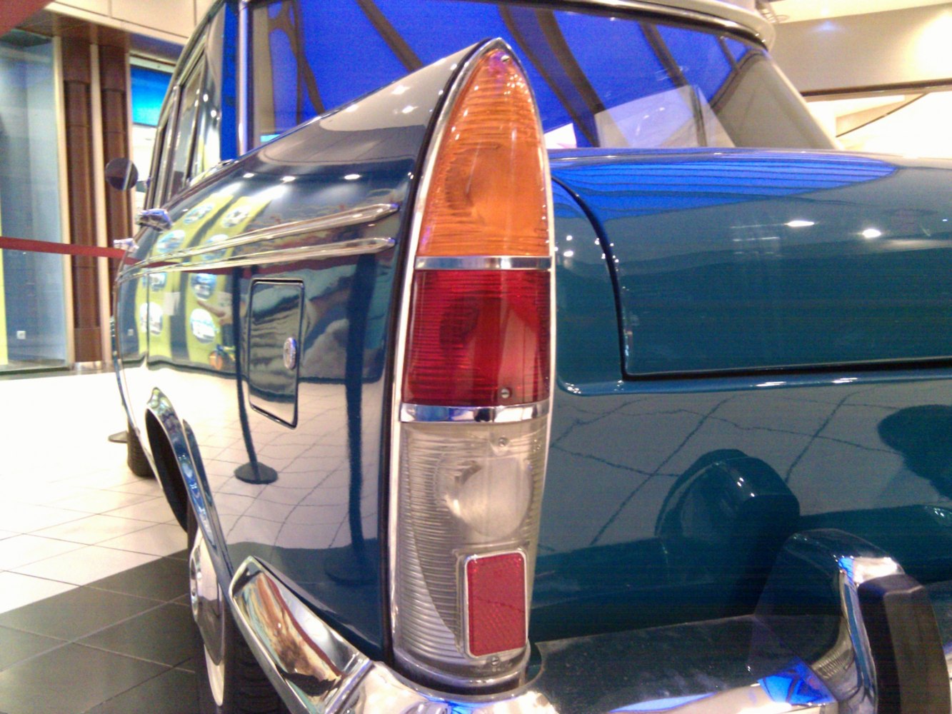 Rear tail light assembly and side badge close-up on classic vintage car