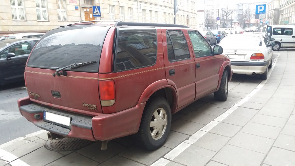 Rear and side view of a classic SUV with tinted windows and rear windshield wiper.