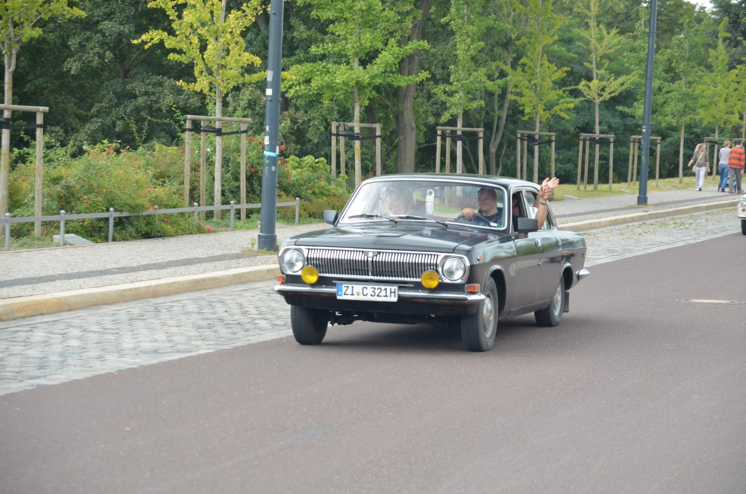 Classic front grille with round headlights and yellow fog lamps.