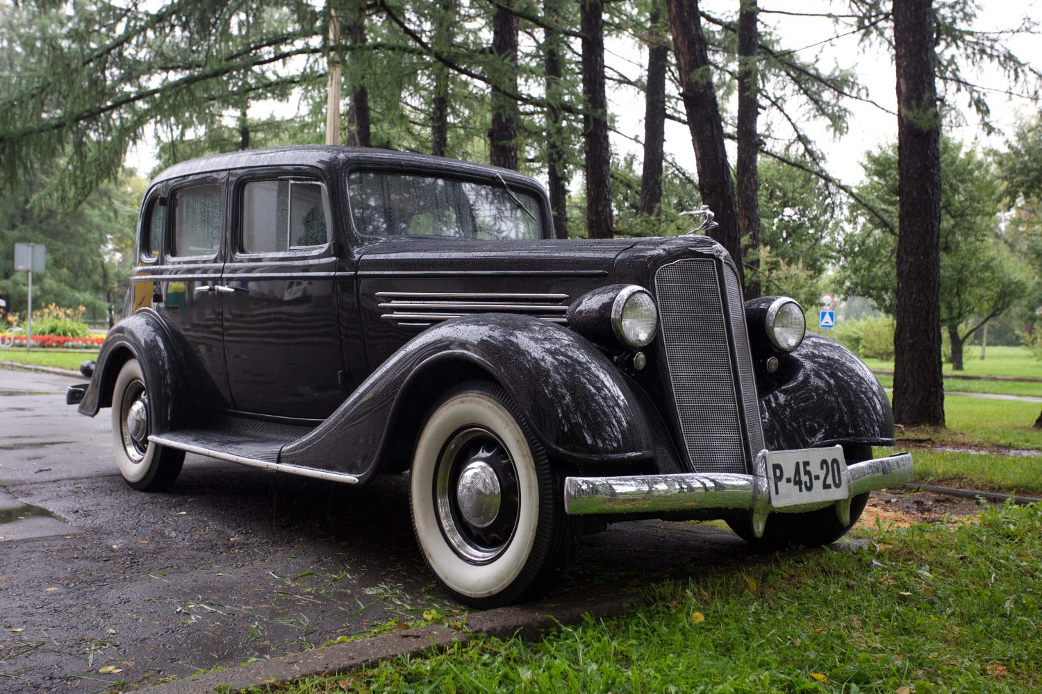 Vintage 1930s sedan with rounded fenders and whitewall tires