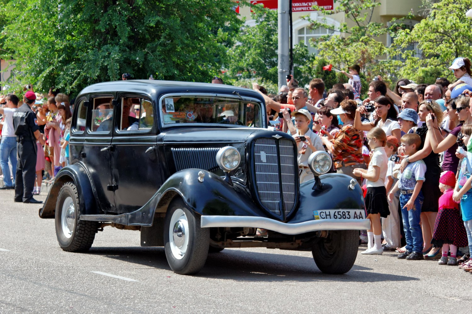 Vintage black 1936 sedan with distinctive front grille and round headlights