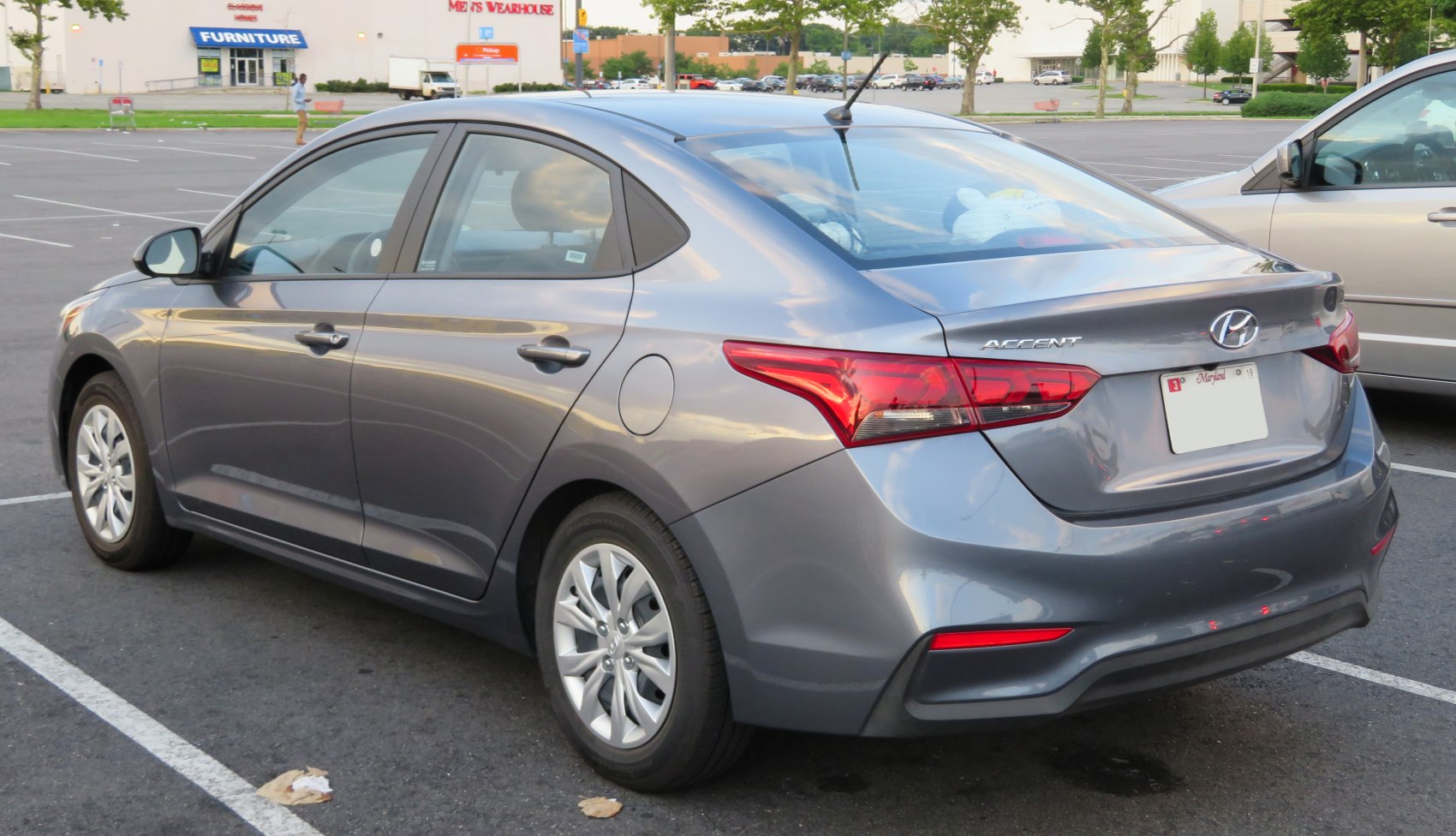 Rear and side view with unique taillight design and smooth body lines.