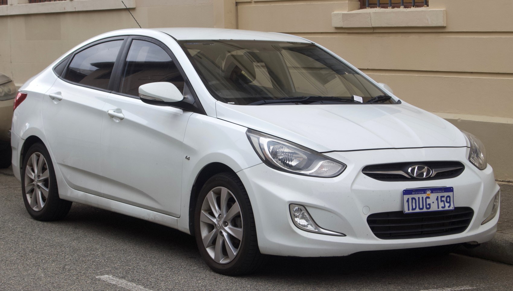 White sedan showing front and side profile