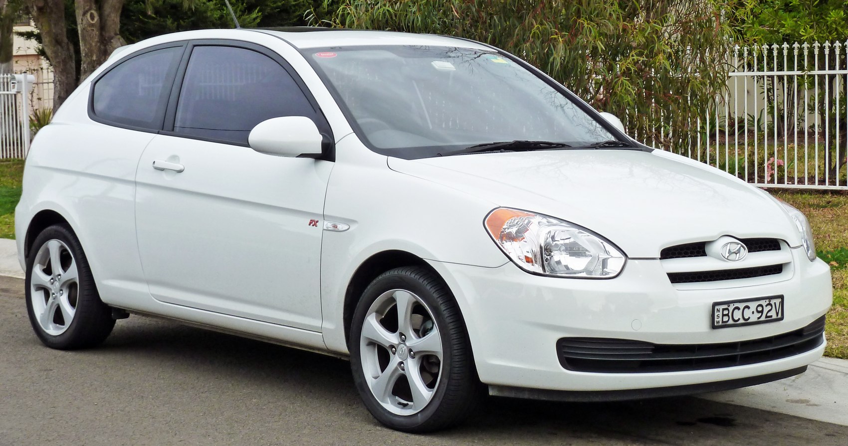 White compact 3-door hatchback with alloy wheels and smoked rear windows