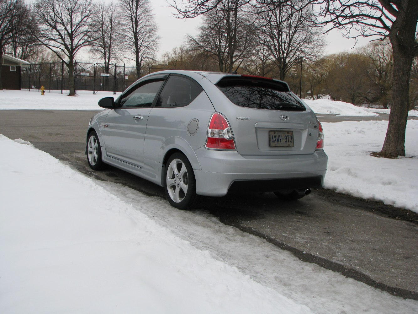 Rear and side view of a silver sporty compact hatchback.