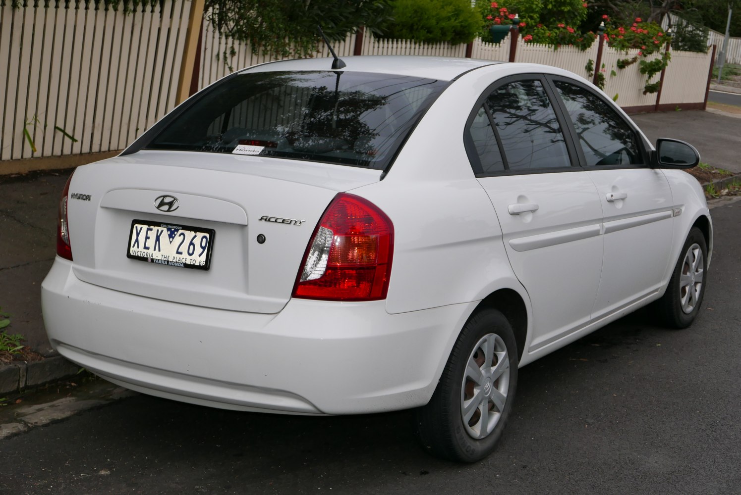 Rear view of compact sedan highlighting tail lights and rear design