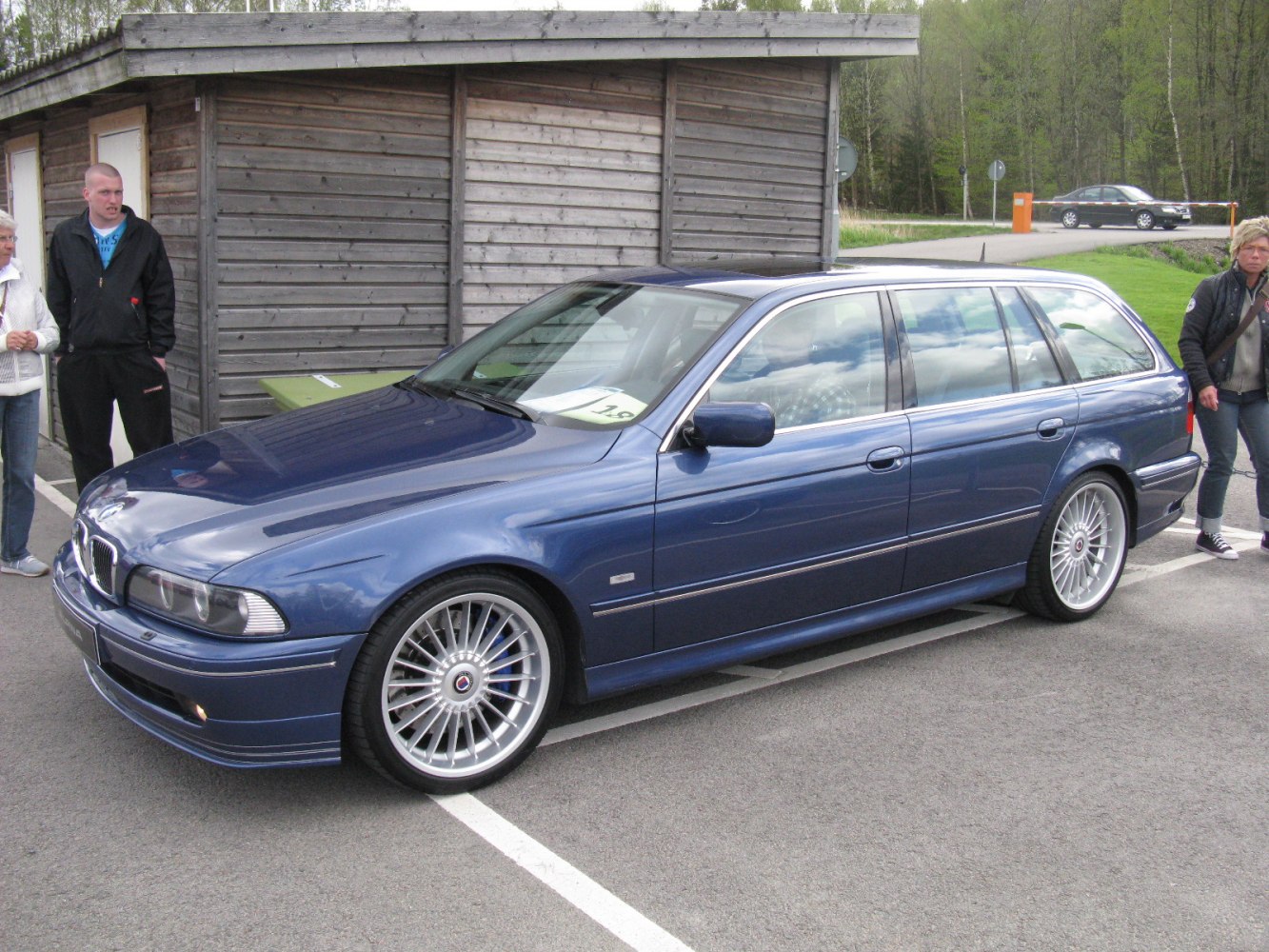 Blue luxury performance wagon with multi-spoke alloy wheels