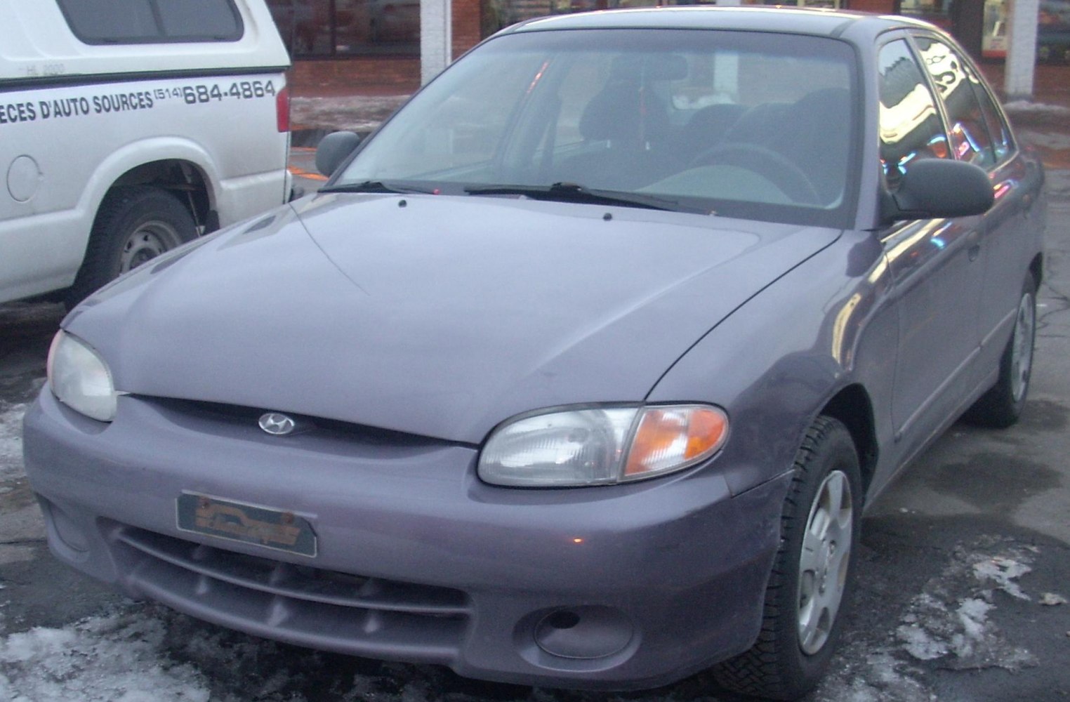 Front view of compact sedan with classic headlights and smooth bumper.