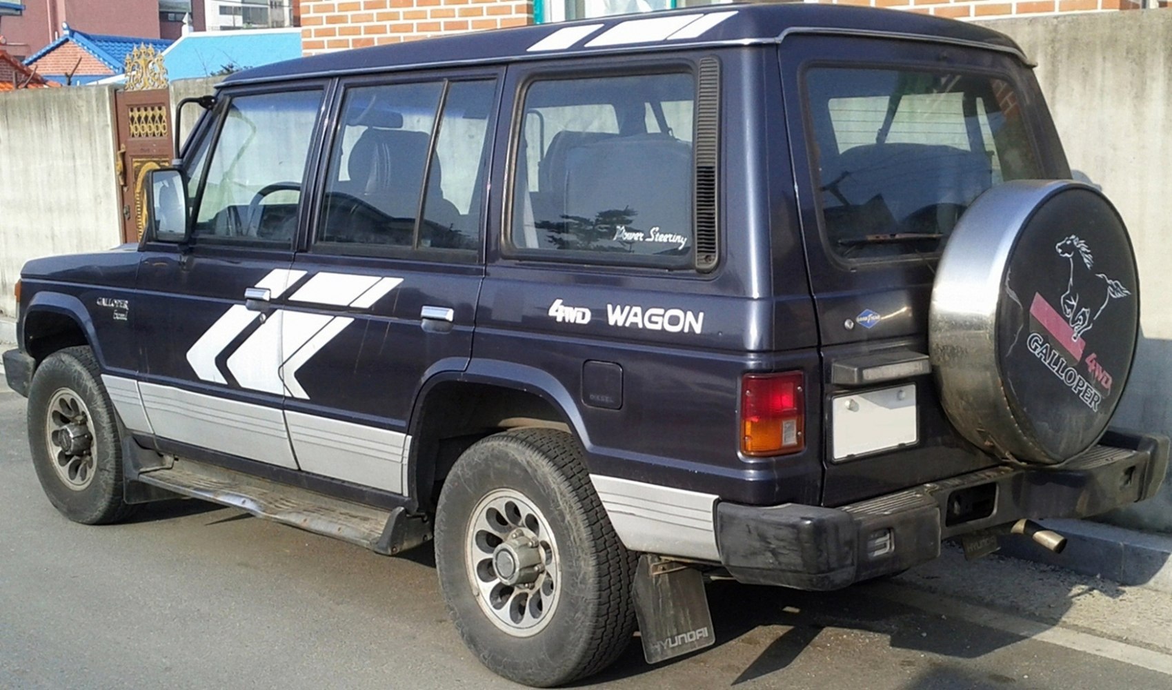 Classic 4WD wagon with side decals and rear spare tire cover